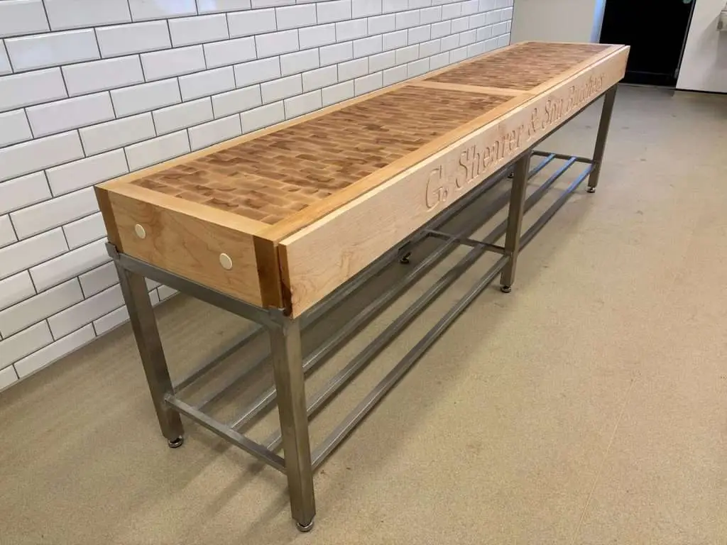 Long timber-topped console table with drawers and a metal frame