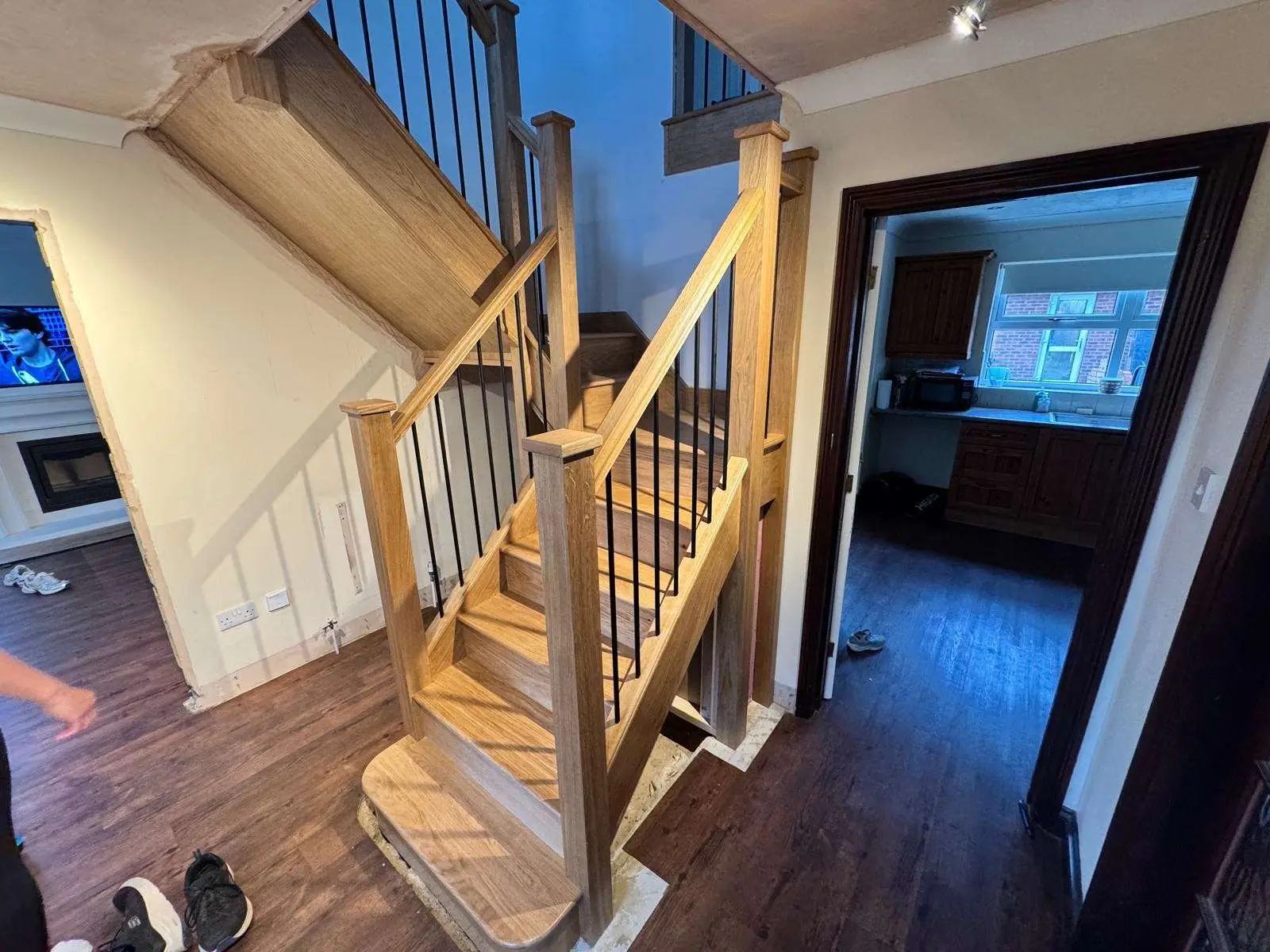 Oak staircase with timber handrails and dark metal balusters