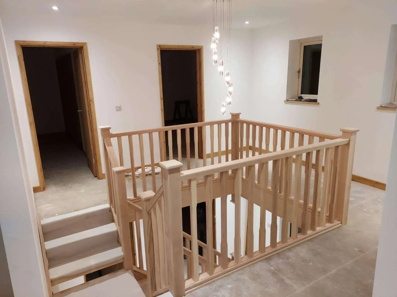 Timber landing balustrade surrounding the top of a staircase
